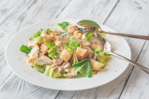 Fresh chicken Caesar salad with lettuce, grilled chicken, croutons and parmesan cheese