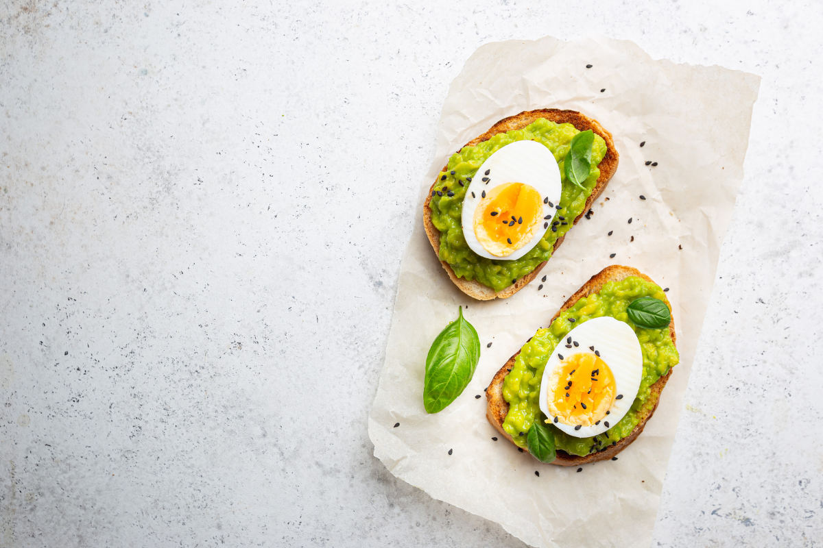 Avocado toast topped with boiled eggs