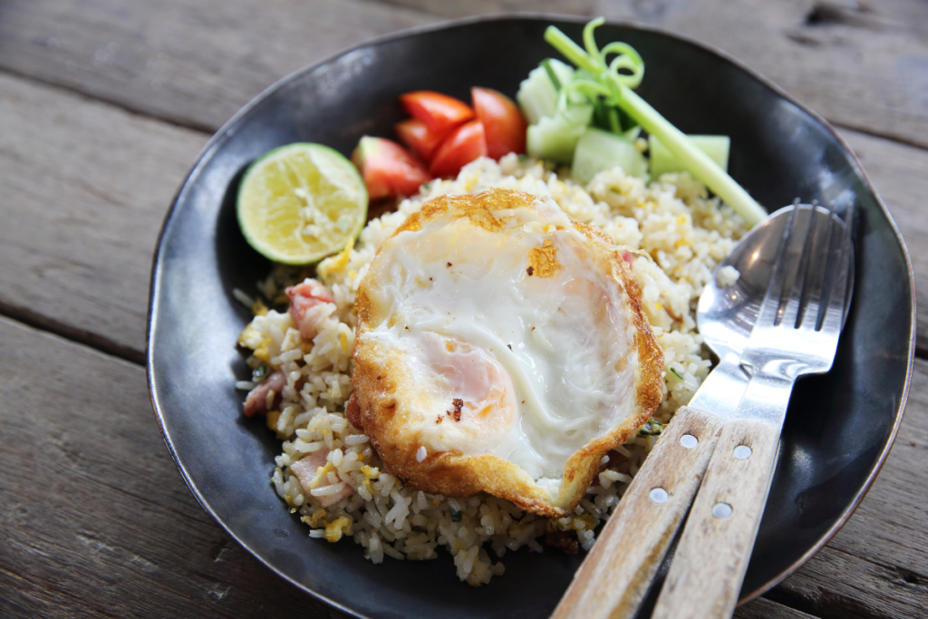 A healthier version of fried rice served with a sunny-side-up egg, fresh vegetables and lime.