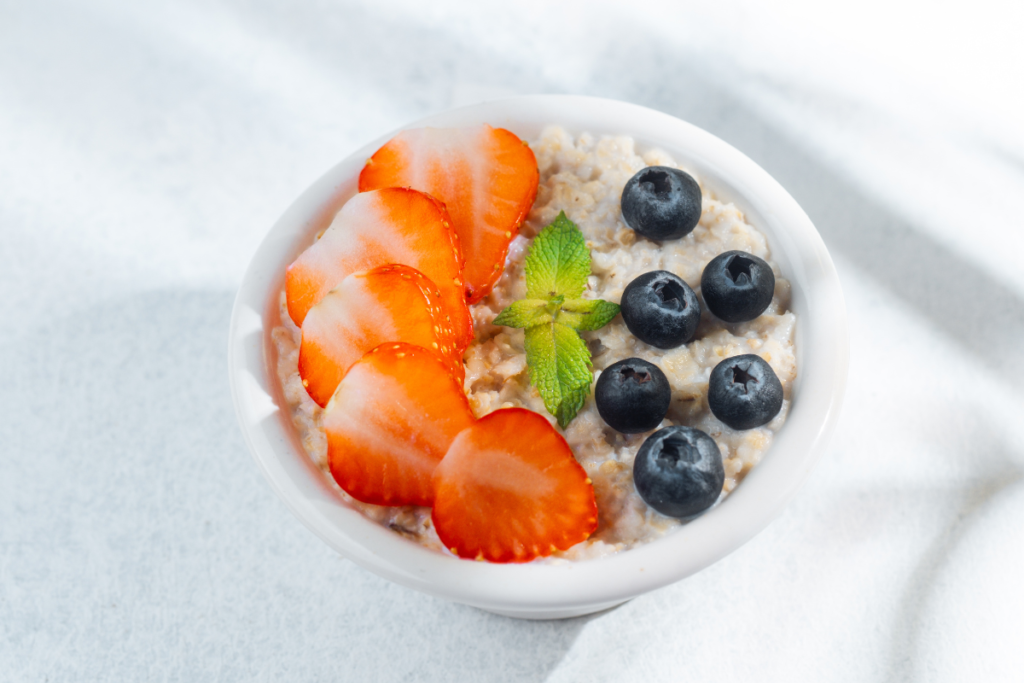 Berry overnight oats topped with fresh strawberries, blueberries and mint
