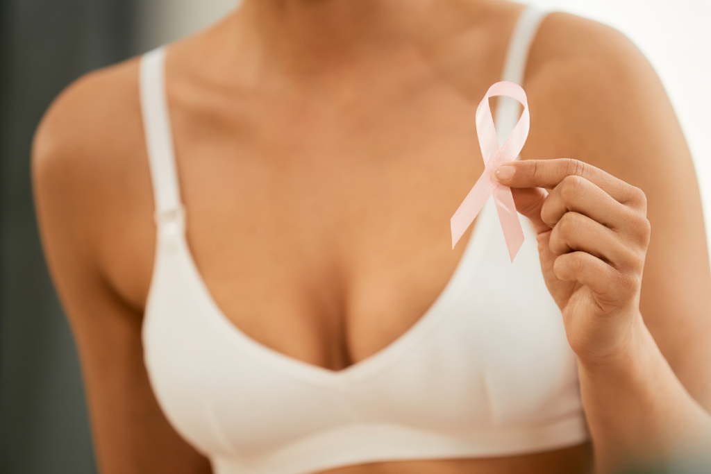 Woman holding a breast cancer awareness ribbon representing breast health awareness