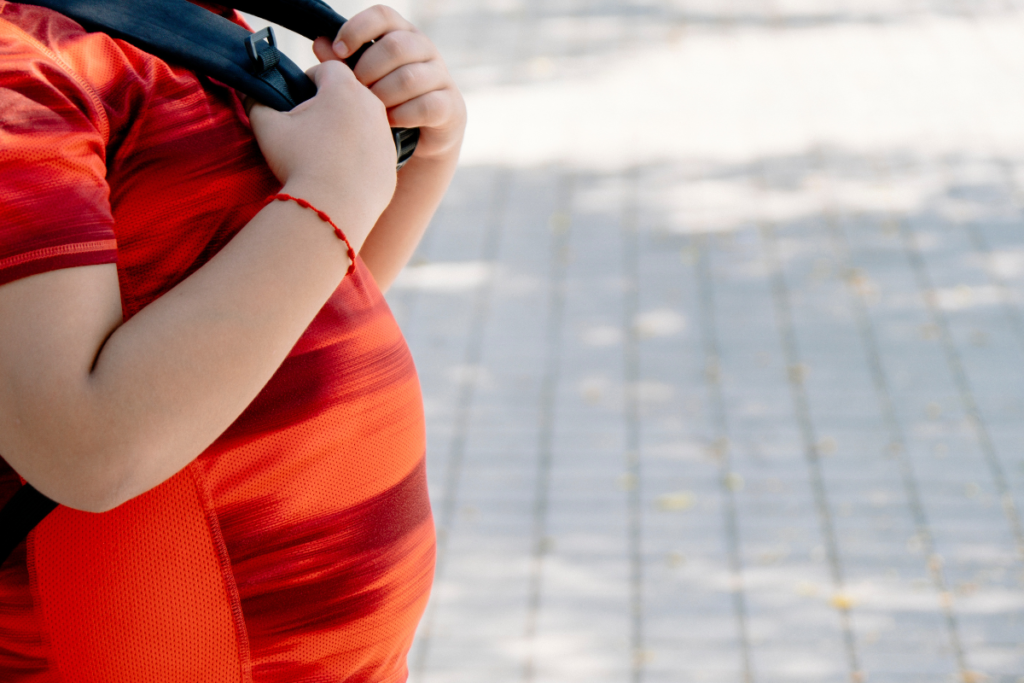 Child with excess body weight outdoors representing childhood obesity and healthy lifestyle awareness