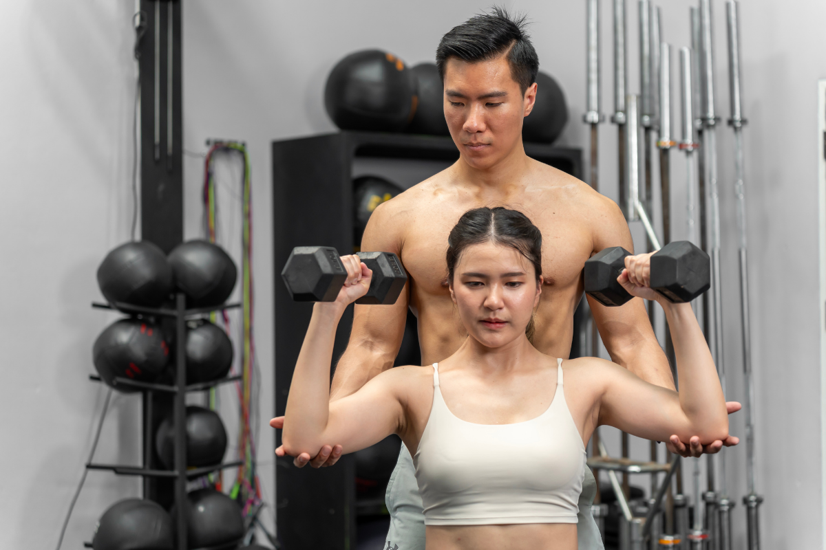 Trainer or fitness instructor working with a client