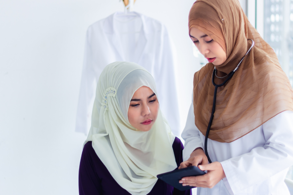 Doctor discussing health information with a female patient during a medical check-up