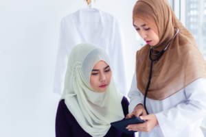 Doctor discussing health information with a female patient during a medical check-up
