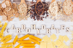 Assortment of whole grains and refined carbohydrate foods including rice, oats, cereals and pasta.