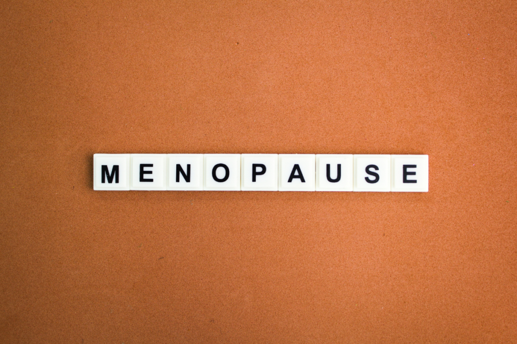 Menopause word displayed on letter tiles representing women's health