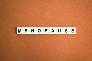 Menopause word displayed on letter tiles representing women's health