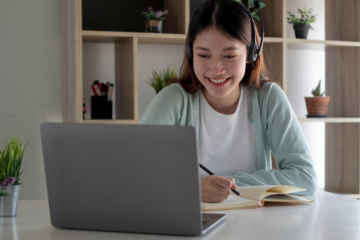 Online course provider working on a laptop