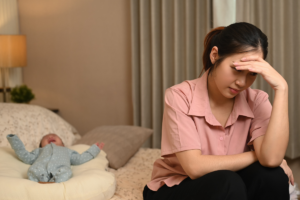 New mother feeling overwhelmed and distressed while caring for her baby at home.