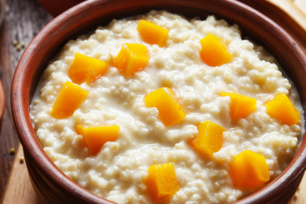 Pumpkin ginger rice porridge in a bowl with soft pumpkin pieces