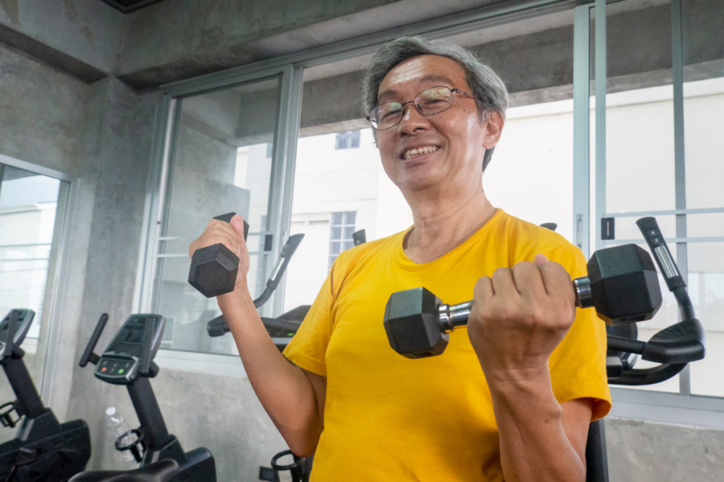 Older man lifting dumbbells during a strength training workout