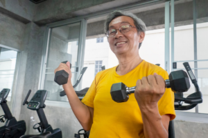 Older man lifting dumbbells during a strength training workout