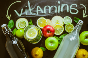 Fresh fruits including apples and citrus fruits representing natural dietary sources of vitamins