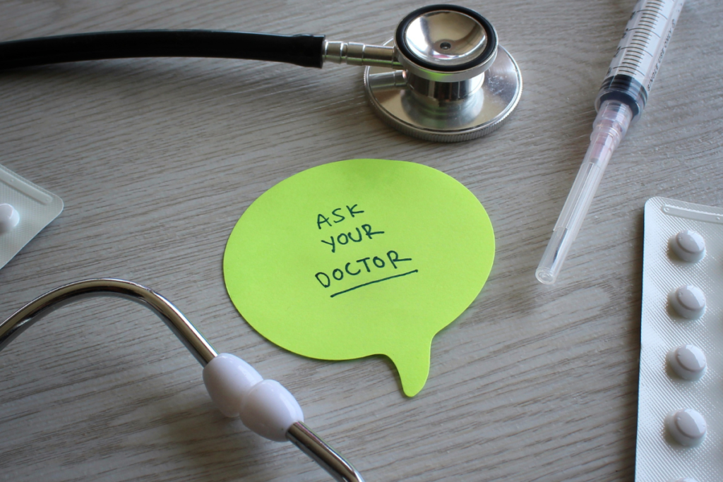 Stethoscope and medical supplies beside a note encouraging people to ask their doctor about their health.